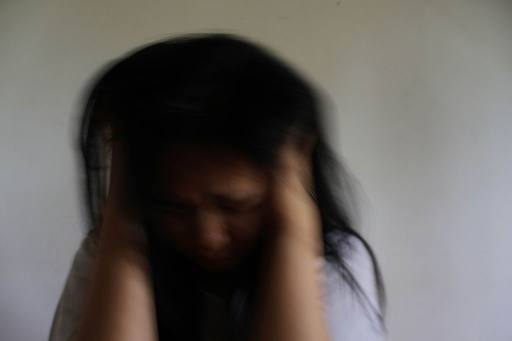 Woman experiencing chronic stress representing elevated cortisol effects