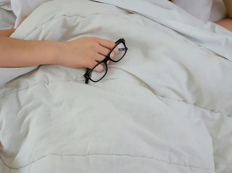 Woman resting in bed representing perimenopause sleep disruption and insomnia