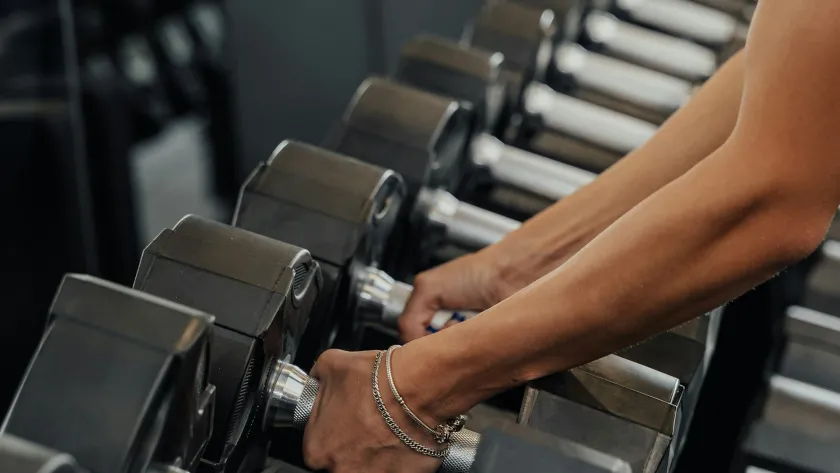 Woman strength training to preserve muscle and metabolism during perimenopause