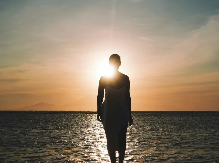 Woman silhouetted at sunset representing perimenopause transition and metabolic change