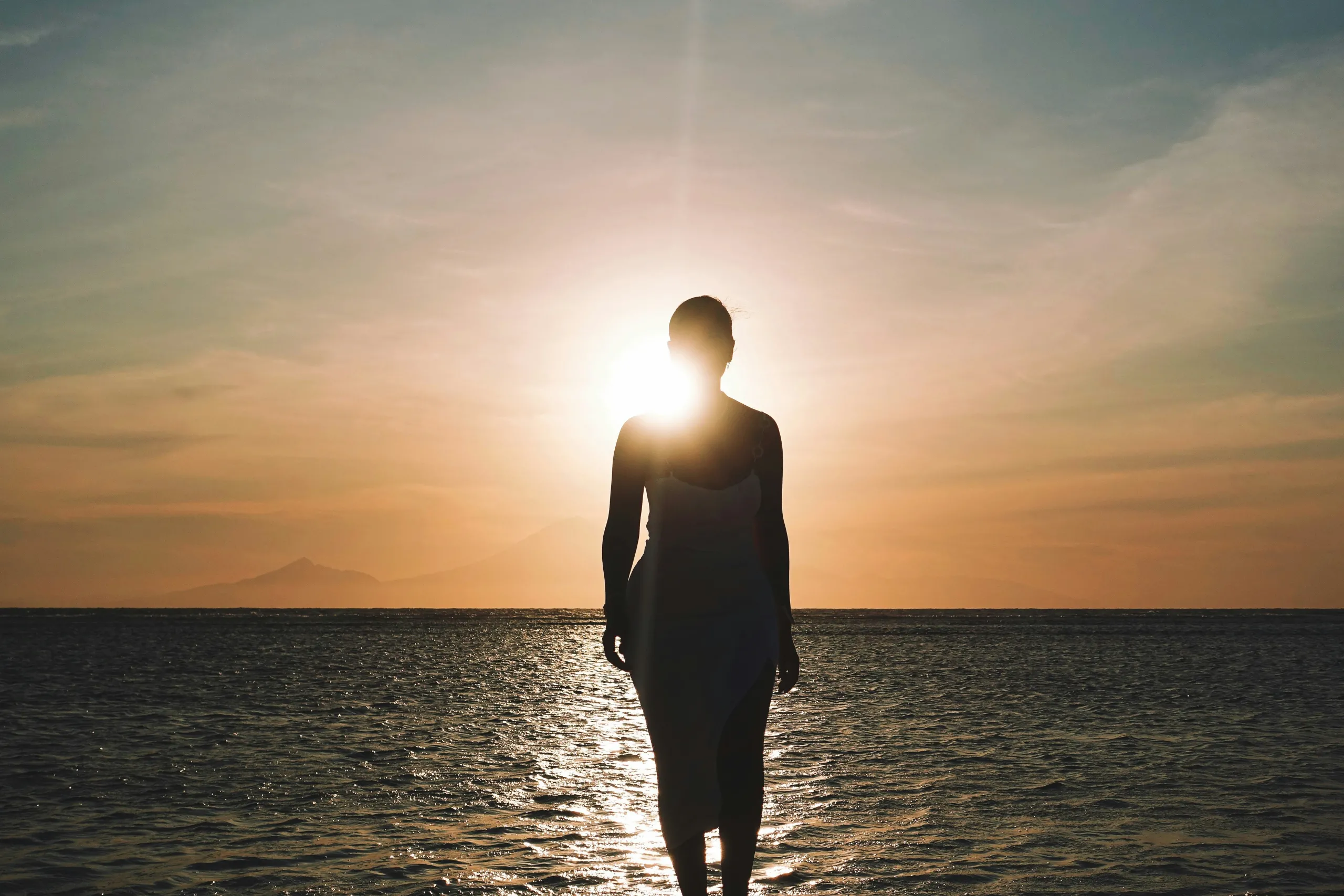 Woman silhouetted at sunset representing perimenopause transition and metabolic change